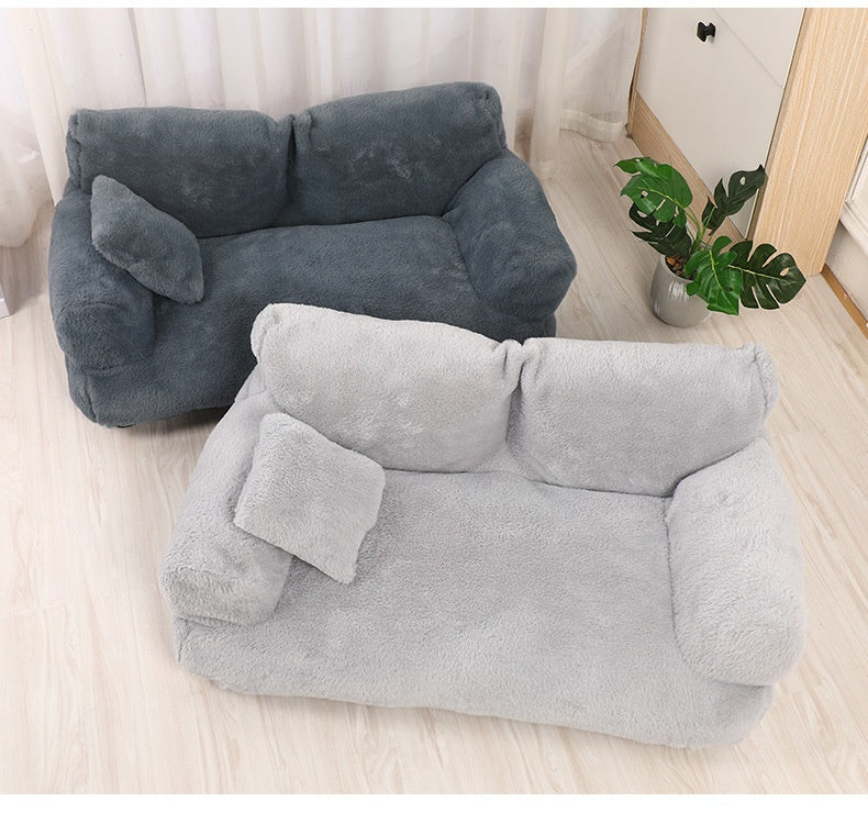 Dog resting in plush sofa nest bed
